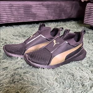 Puma Slip-On Sneakers in Black and Gold Accent